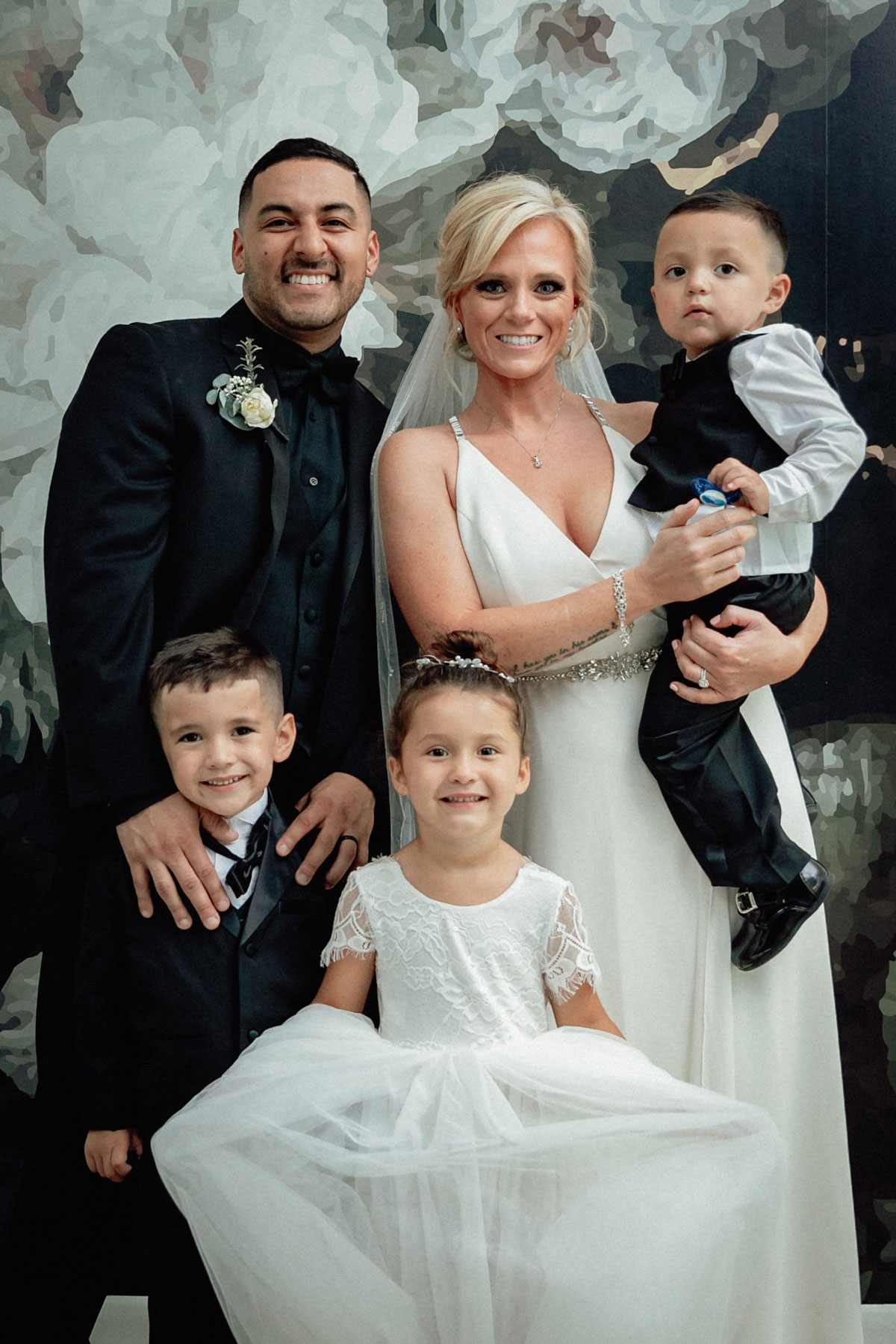 Family portrait of the bride, groom, and their children on the day of their elopement