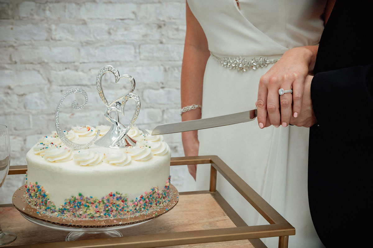 Bride and groom cutting their wedding cake on the day of their elopement